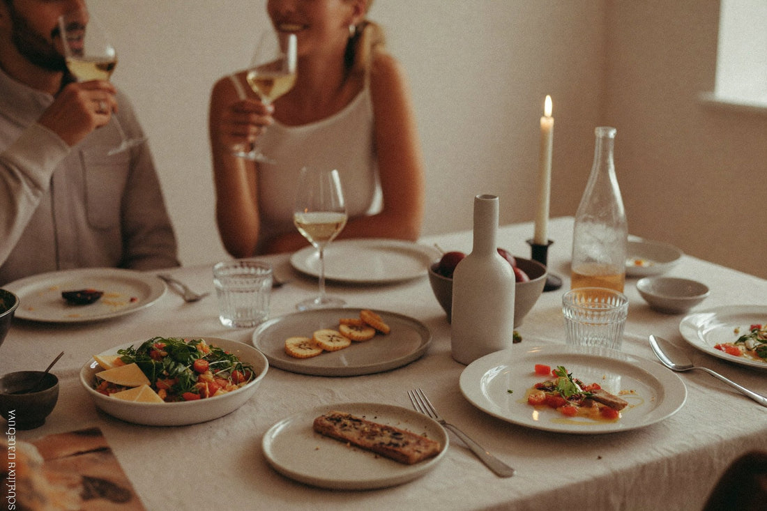 Friends at the table with white wine and set plates