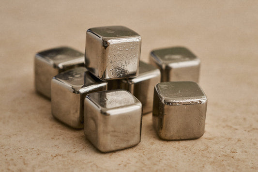 Solid stainless steel ice cubes on a light surface