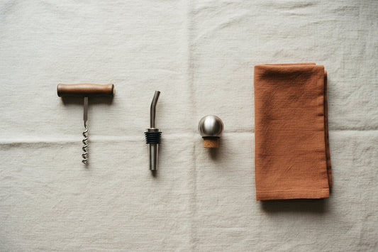 Wine accessories laid out in a row on a linen cloth